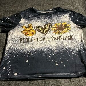 A woman small blue shirt with white dots and floral designs